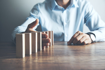 Man and wooden cubes on table