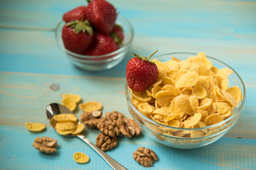 Tasty cornflakes witt walnut in glass bowl