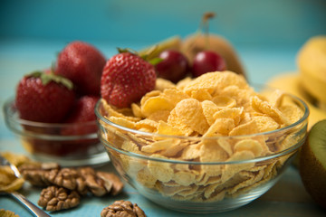 Tasty cornflakes witt walnut in glass bowl