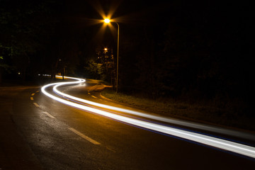 A long exposure of a road with light trail along the road