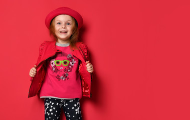 Five years old baby girl child kid posing in red leather jacket and hat screaming yelling