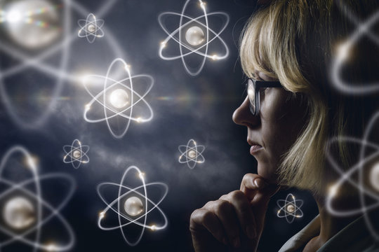 Woman looking explores atoms .