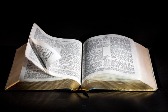 Open Bible on dark tablet