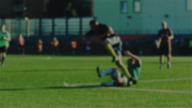 Fullback slides tackle and foul for free kick with not fair paly, soccer game, blurred for background