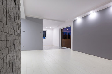 Naklejka na ściany i meble Living room with new laminated floor and decorative wall