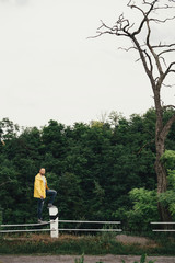 a man in a yellow raincoat with a camera