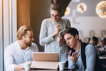 Three Businesspeople Working In cafe