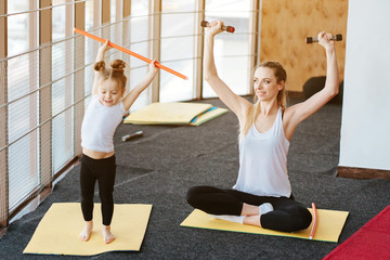 Mom and daughter together perform different exercises