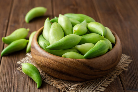Cyclanthera pedata or kaywa or caigua or achuqcha - Latin American vegetable in bowl on wooden background. Selective focus.