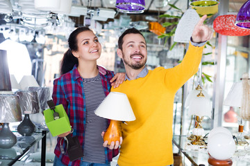 Man with girl points to interesting lamp