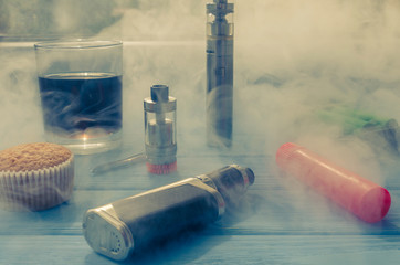 Still life with e-ciggarete and coffe on the wooden background