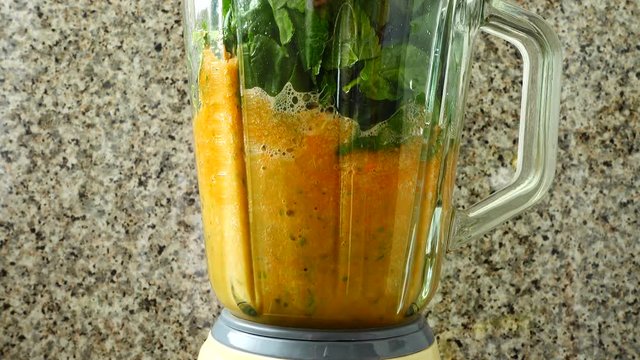 Cocktail from carrots, a stalk of a apium and spinacia.	Process of preparation of cocktail.