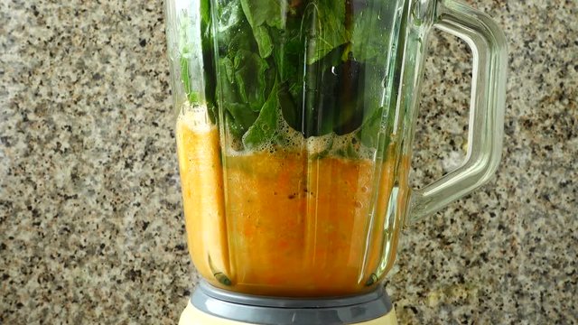 Cocktail from carrots, a stalk of a apium and spinacia.	Process of preparation of cocktail.
