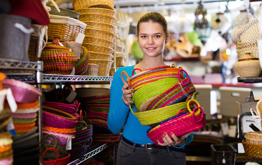 Young female choosing colour wicker basket