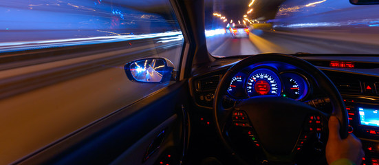 Movement of the car at night at a speed view from the interior, Brilliant road with lights with a...