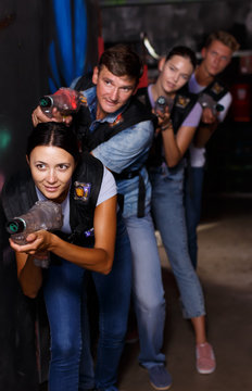 Group portrait of people playing laser tag  game