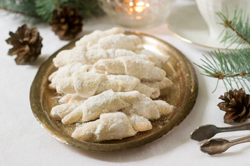 Traditional Romanian or Moldovan shortcake cookies with jam stuffing and a cup of tea on the background of winter decor.