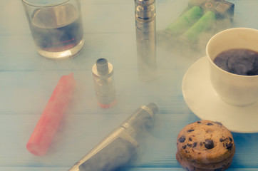 Still life with e-ciggarete and coffe on the wooden background