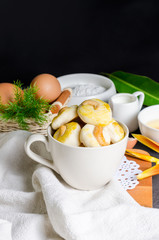 Close up cookies with cashew nut in a white cup.