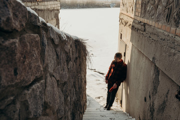 Tourist in urban area looking in forward and exploring freedom and nature. Winter snowy urban landscape Adventure active vacations and cold weather.