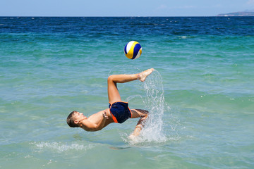 boy performs the overturned in the sea