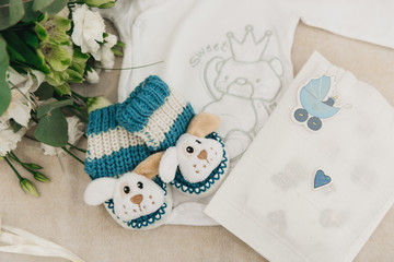 Details of the photo shoot waiting for the baby. Parents are waiting for the appearance of the son, beautiful things for the baby