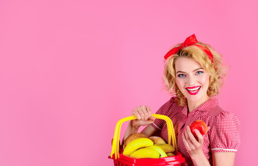 Gastronomy. Healthy food. Sale, discount, shopping, consumerism. Woman with food basket and apple at grocery store or supermarket. Shopping series. Girl hold shopping basket with groceries. Copy space