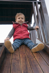 Naklejka premium baby boy in a park at the playground