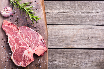 Raw beef steak T bone with ingredient