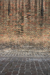 Aged weathered street wall. Architecture detail background. Old red brick wall