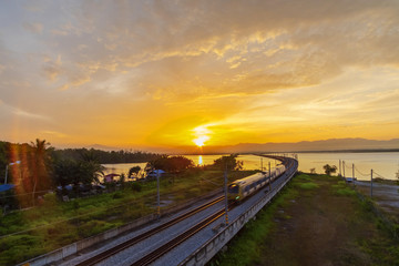 Obraz premium Beautiful Sunrise over Floating Railway at ‘Bukit Merah,Malaysia’ .soft focus,blur due to Long Exposure Shoot. Visible Noise due to High ISO.