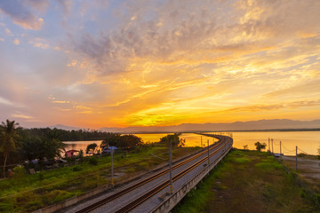 Beautiful Sunrise over Floating Railway at ‘Bukit Merah,Malaysia’ .soft focus,blur due to Long Exposure Shoot. Visible Noise due to High ISO.