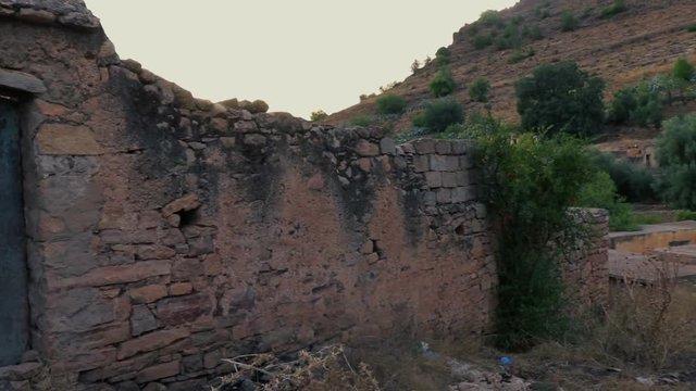 Old ancient ruins of abandoned buildings in Algeria, Tlemcen, hills and mountains in background