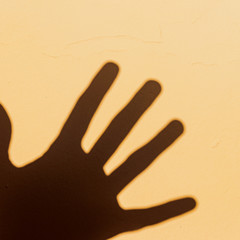 Show of hand doing shadowplay against wall