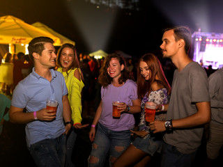 Friends enjoy in Rock concert on the field