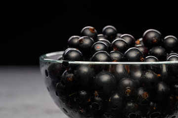 Photo of black currant in glass transparent cup