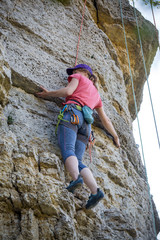 Photo of sports woman climbing mountain