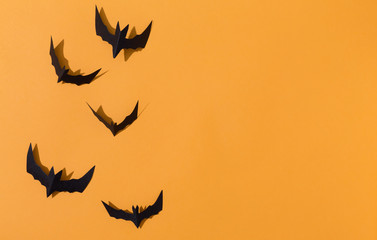 Fototapeta premium Halloween paper bats overhead view on a solid color