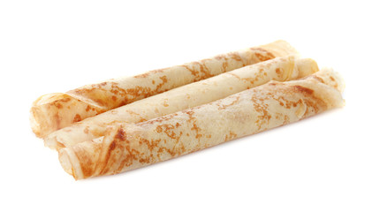 Tasty thin pancake rolls on white background