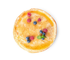 Tasty thin pancakes with maple syrup and fresh berries on white background, top view