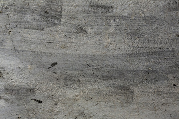 Dirty burnt gray wall detail with dominantly black and white colors as close up grungy stainy textured background for desktop. Creative photography in dark sense for depressive shady wallpaper.
