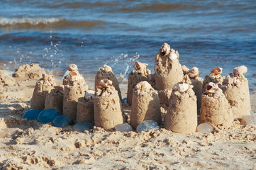 built castle of sand on the beach of the ocean on a clear summer day a clear sunny summer