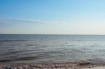 Beach on the shore of the ocean, the sea is a clear sunny summer