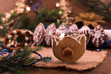 Homemade Christmas cookies in the shape of a pig's head next to Christmas decorations.