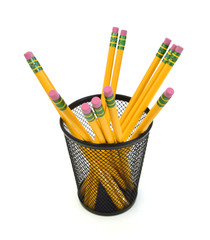 Pencils in a black pencil holder, photographed over plain background with copy space.
