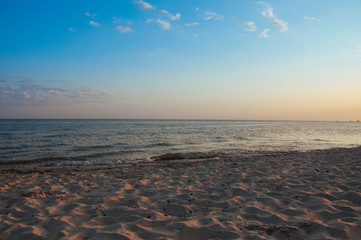 Warm blue sunset on the shore of the ocean, the sea, at sunset on a summer