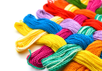 Colorful thread on white background with copy space.