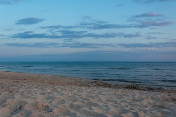 Warm blue sunset on the shore of the ocean, the sea, at sunset on a summer