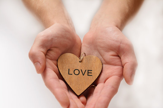 Loving heart in hands a white background