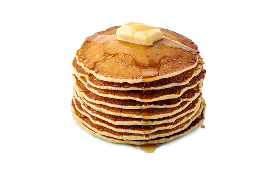 Stack of pancakes with butter and maple syrup on white